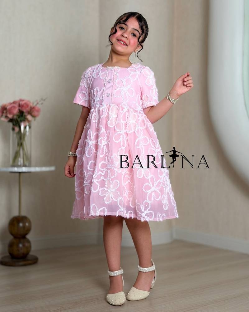 Pink girl's dress embroidered with white roses