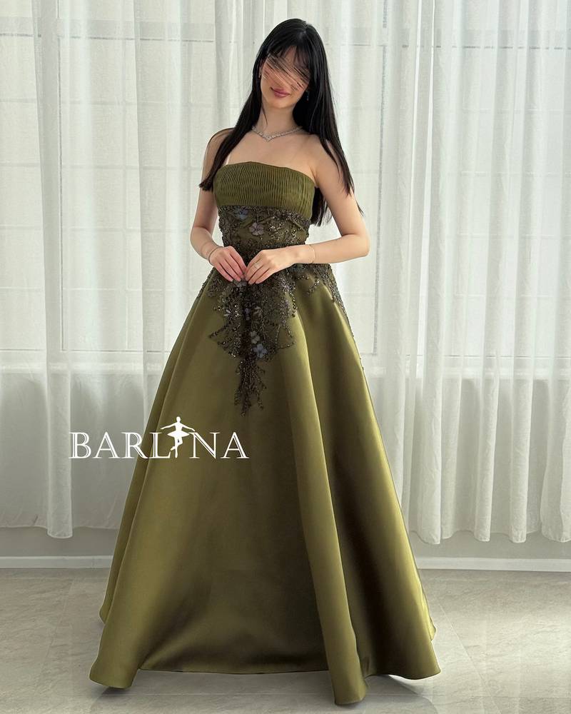 Long green evening dress with a ruffled bodice