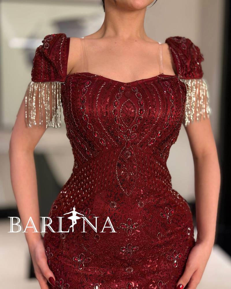 A burgundy dress fully embroidered with sparkling details