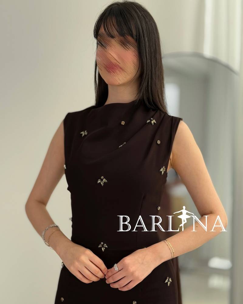 Black dress with crystal embellishments and a draped collar