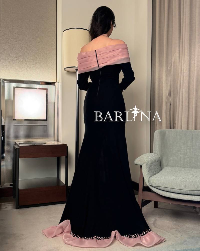 A black dress with pink details and elegant ruffles
