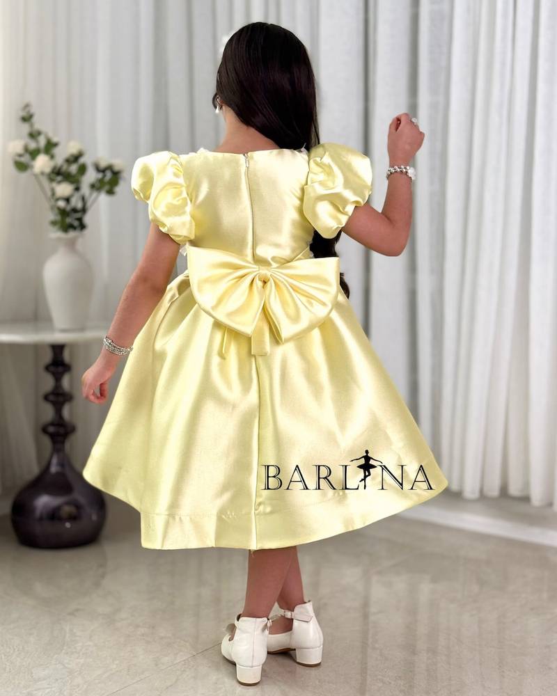 Yellow girl's dress with a bodice decorated with roses