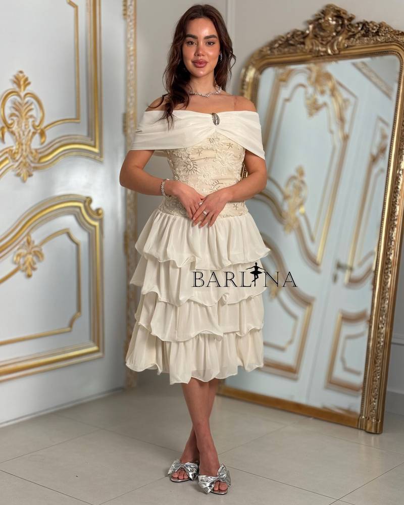 Ivory layered dress with an off-the-shoulder neckline