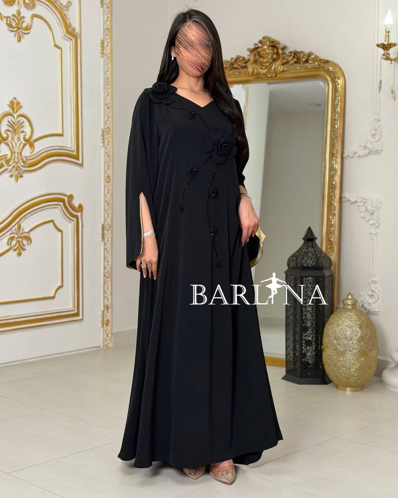 Black jalabiya with green sleeves decorated with roses