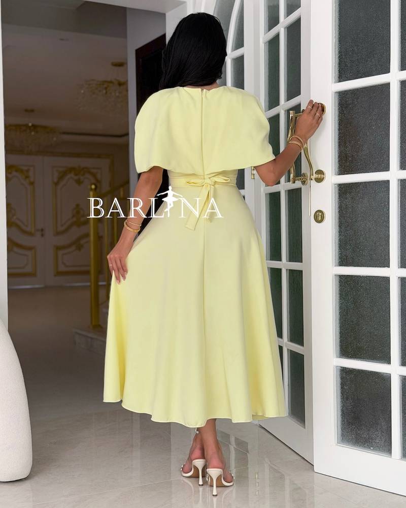 Yellow dress with an off-the-shoulder piece and a crystal belt
