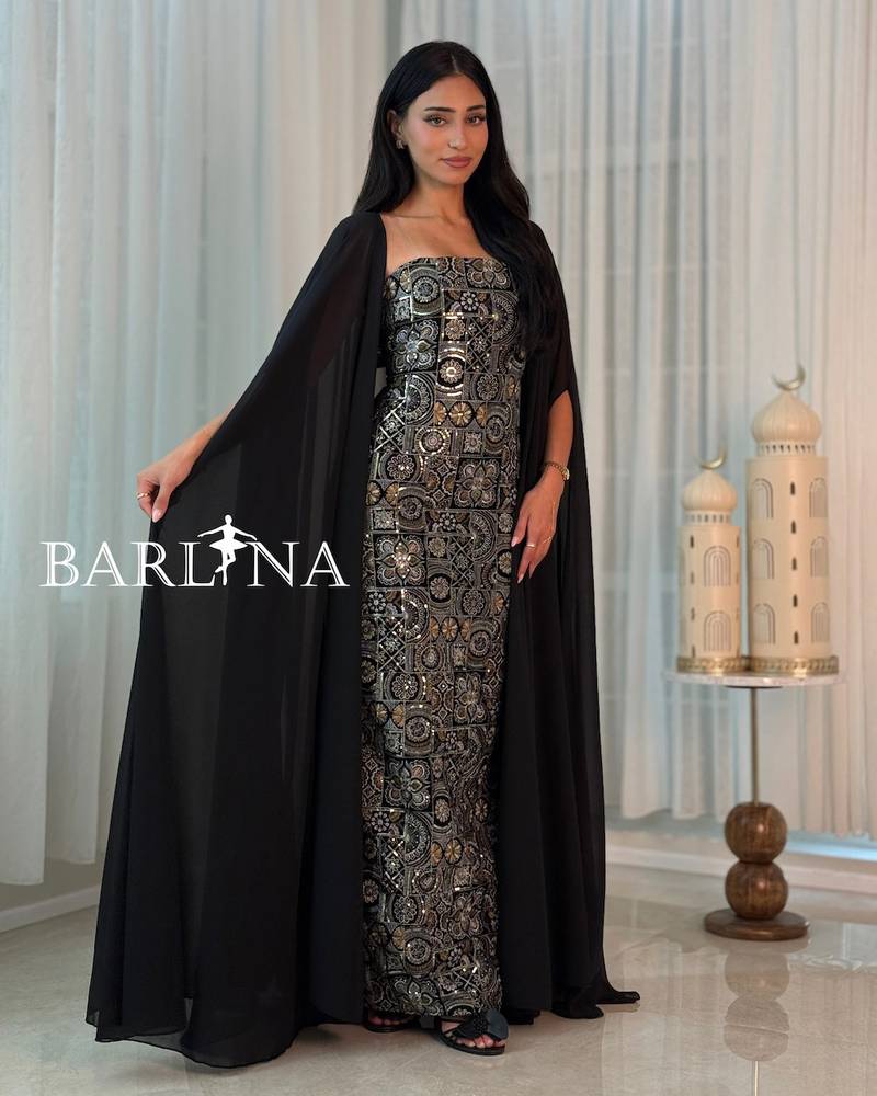 A black jalabiya adorned with luxurious gold patterns