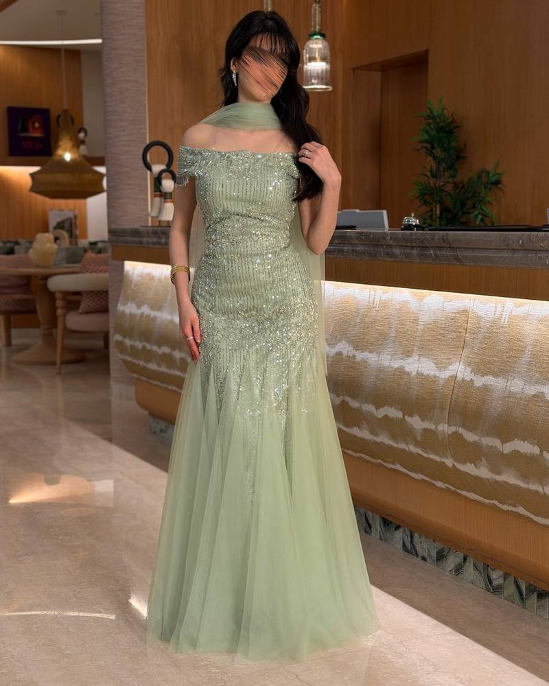 Light green evening dress with a tulle shawl