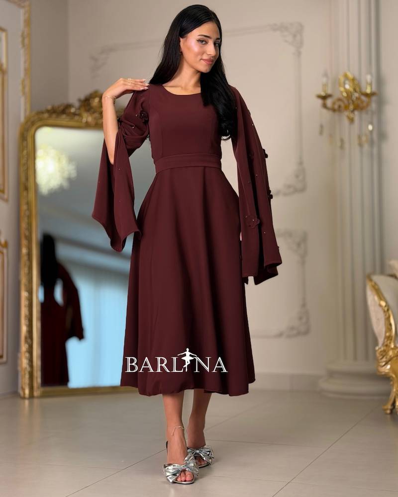Burgundy dress with sleeves adorned with prominent roses