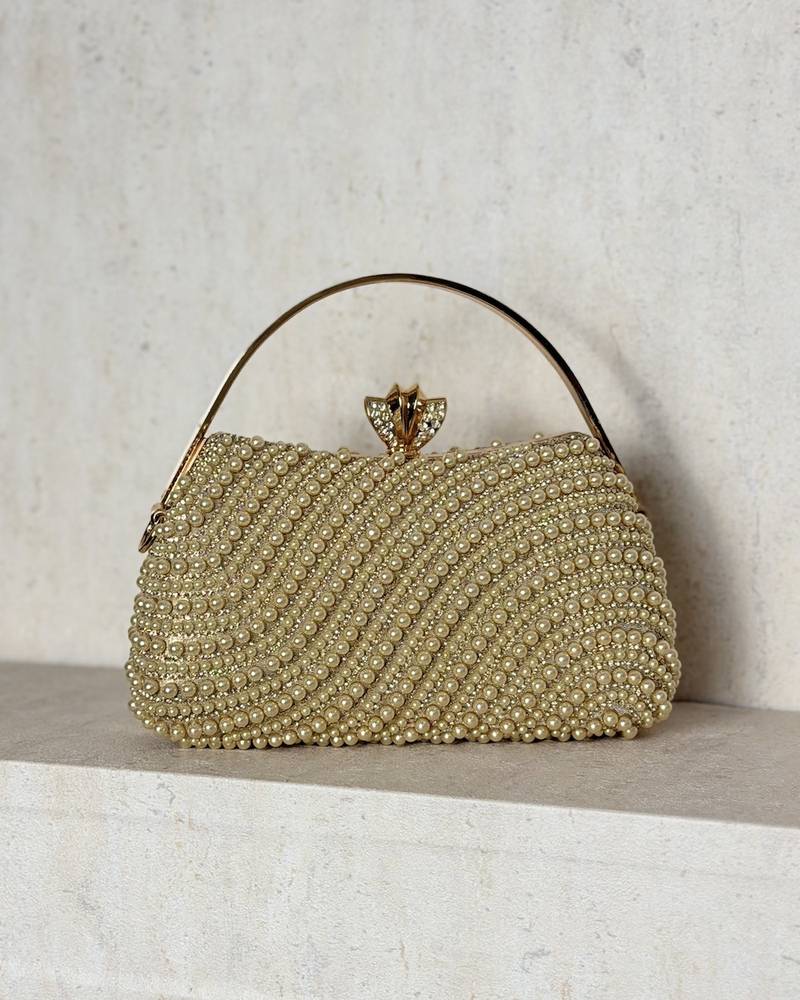 An evening bag adorned with matching pearls