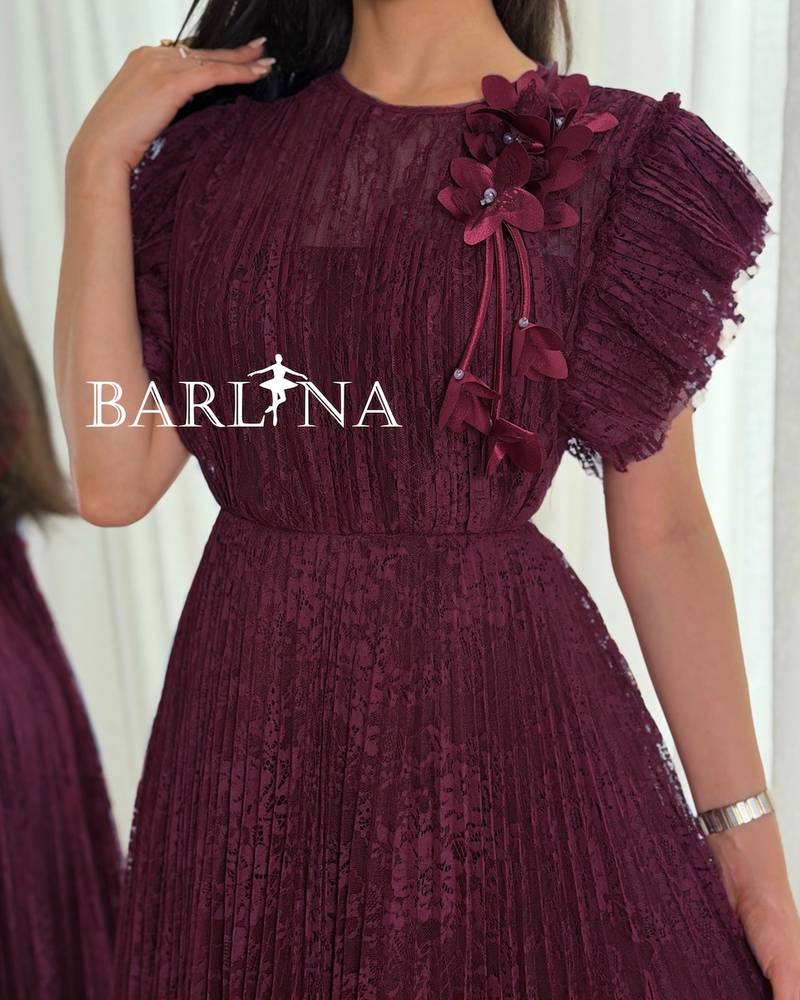 A burgundy dress made of lace fabric with ruffled sleeves