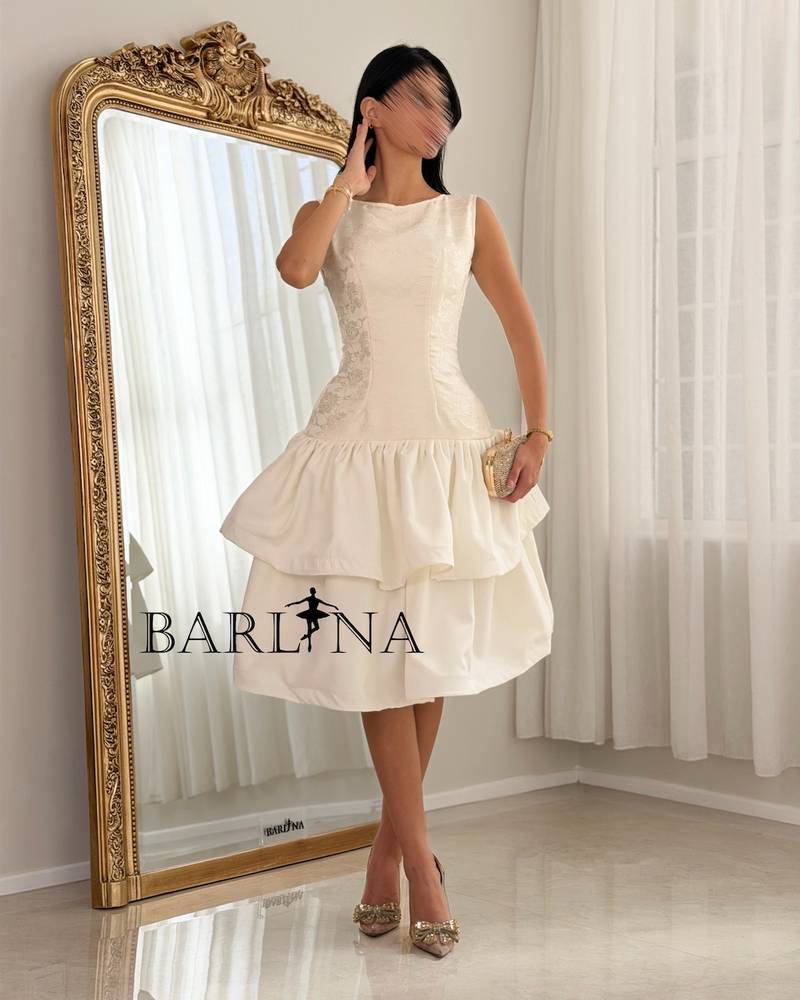 A soft dress with a low waist and layers of ruffles