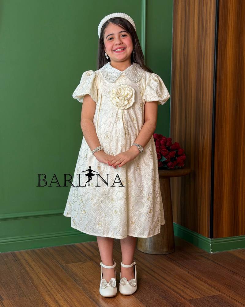 A girl's dress decorated with circle patterns and a raised rose