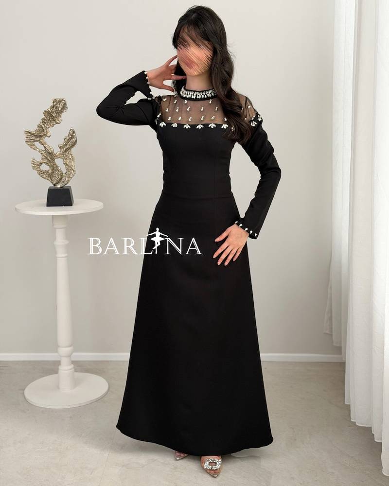 Black dress with a crystal-embroidered sheer neckline