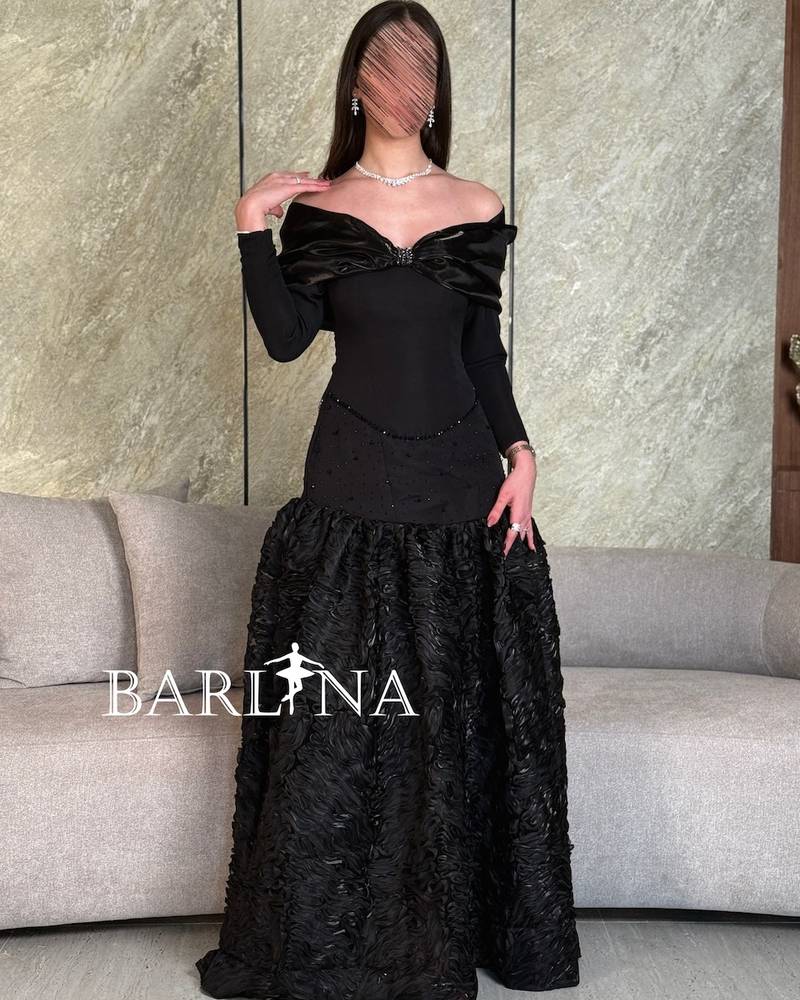 Black dress with prominent fabric and long sleeves
