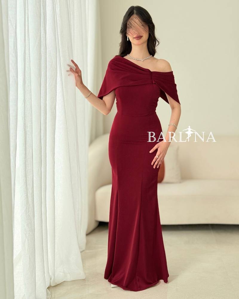 A soft burgundy dress with wide draped shoulders