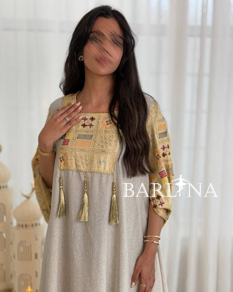 Beige jalabiya with delicate embroidery details at the top