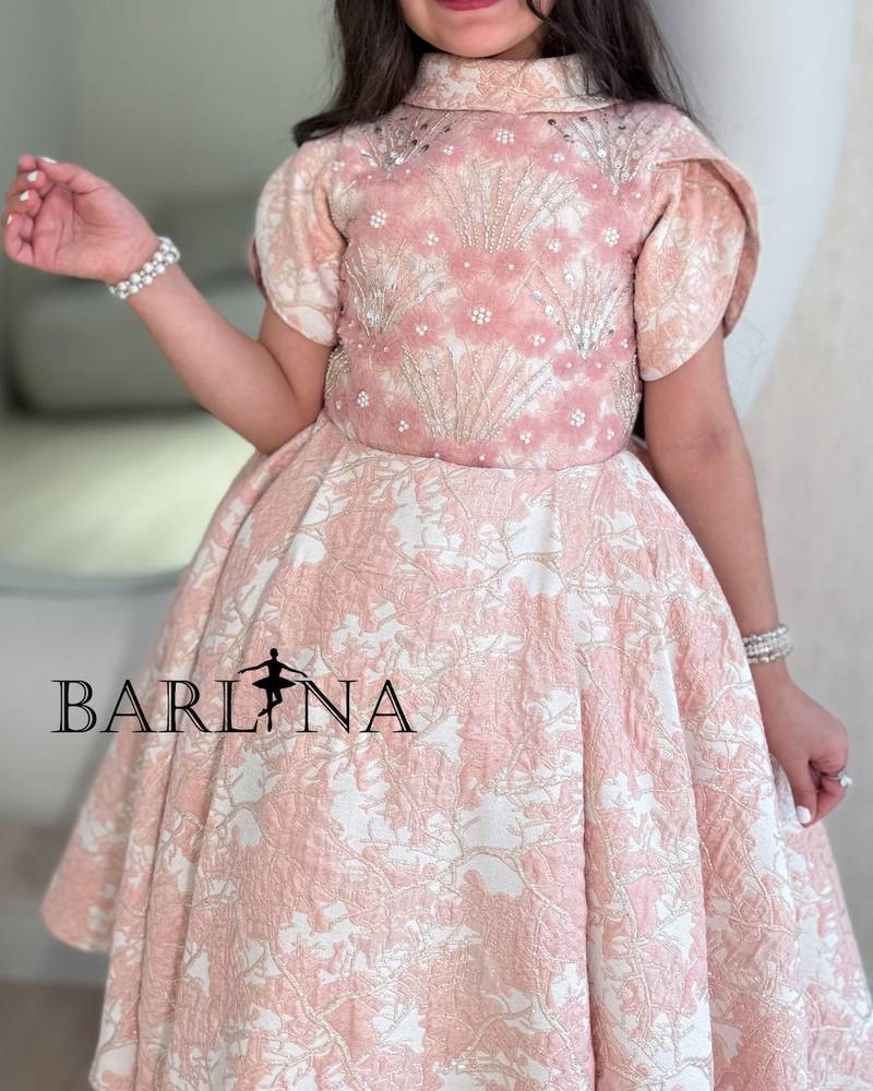 Pink girls' dress decorated with roses
