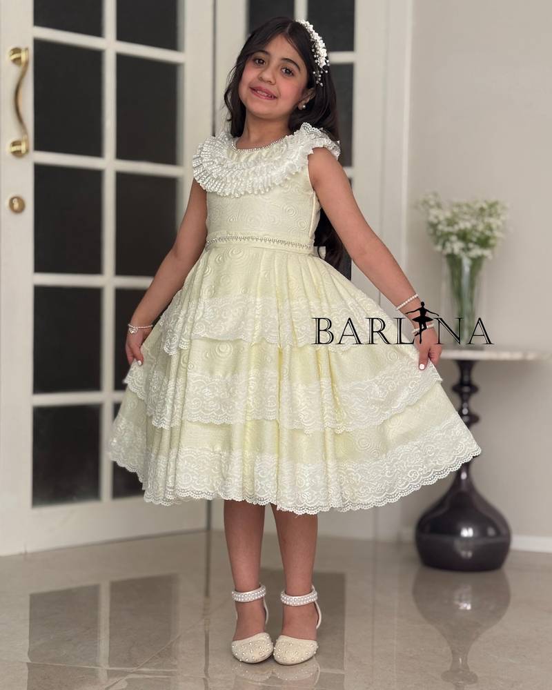 Girls' evening dress adorned with luxurious trim