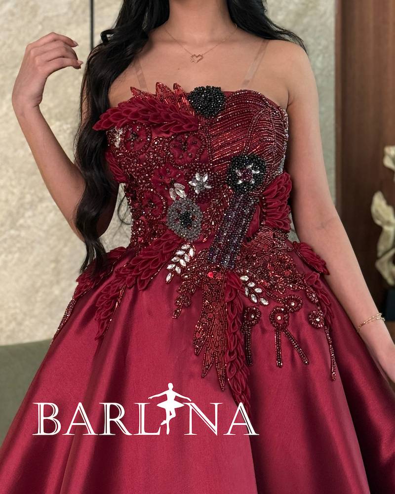 Burgundy dress with prominent beaded and sequin embroidery