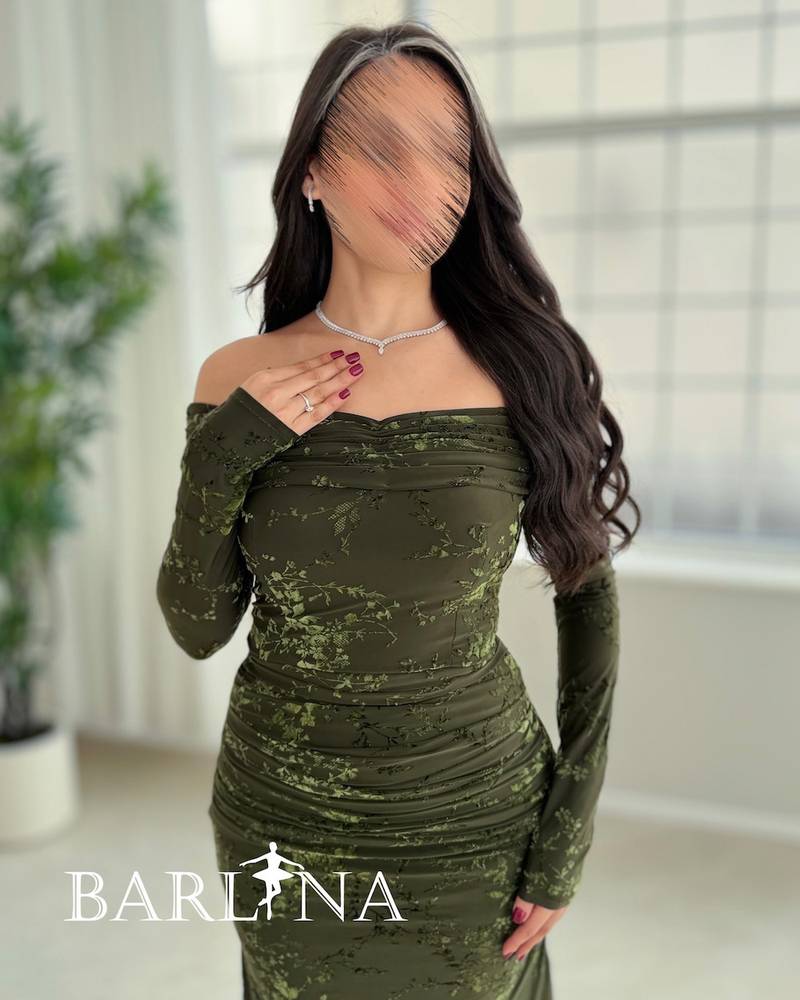 A green dress with a subtle pattern and a hint of shine.
