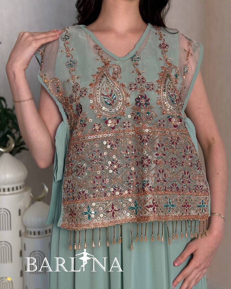 A luxurious jalabiya with an embroidered layer and a traditional touch.
