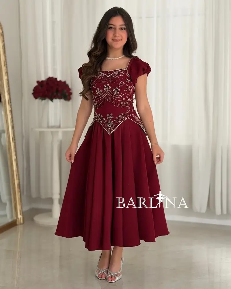 A flowing red dress with elegant beadwork