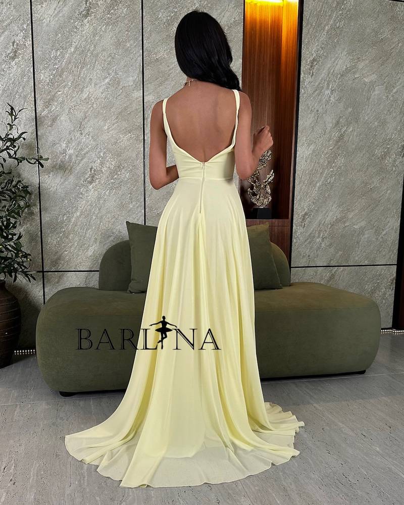 Lemon yellow dress with a slit and ruffle detail