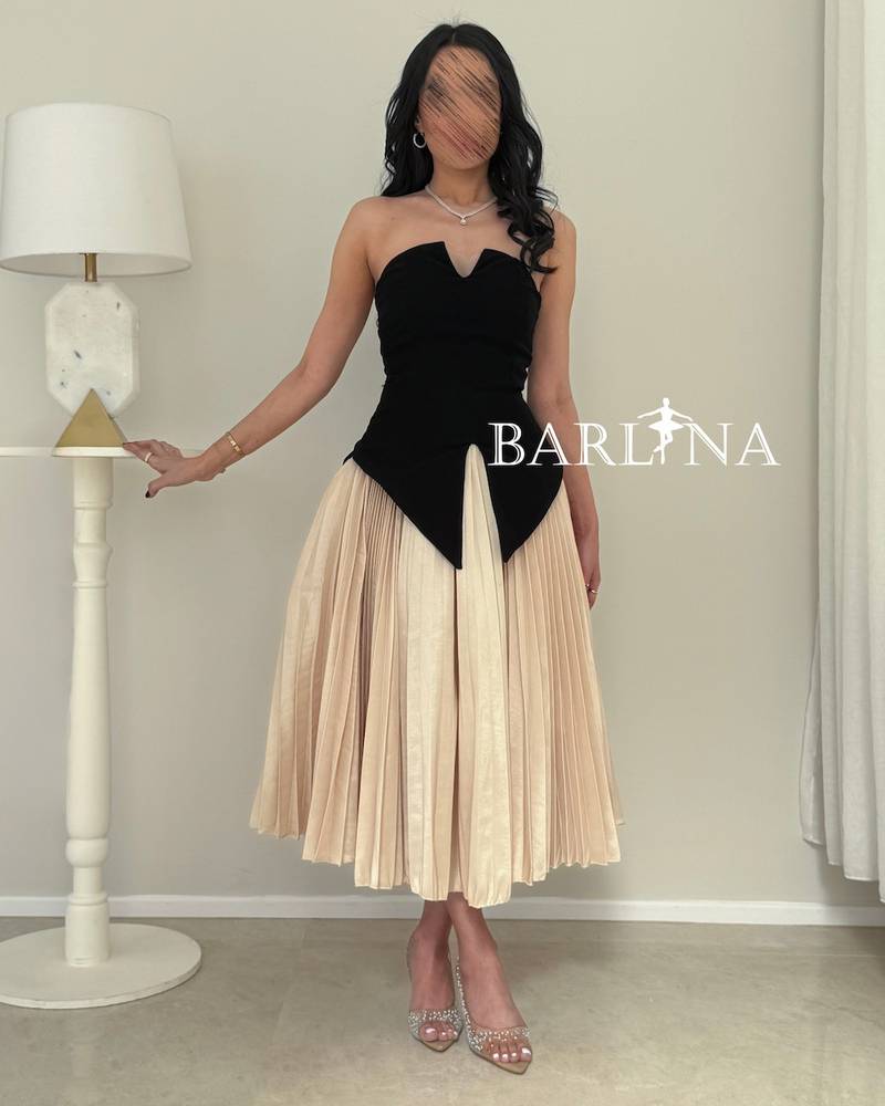 A soft, elegant dress with a corset cut and stylish pleats.