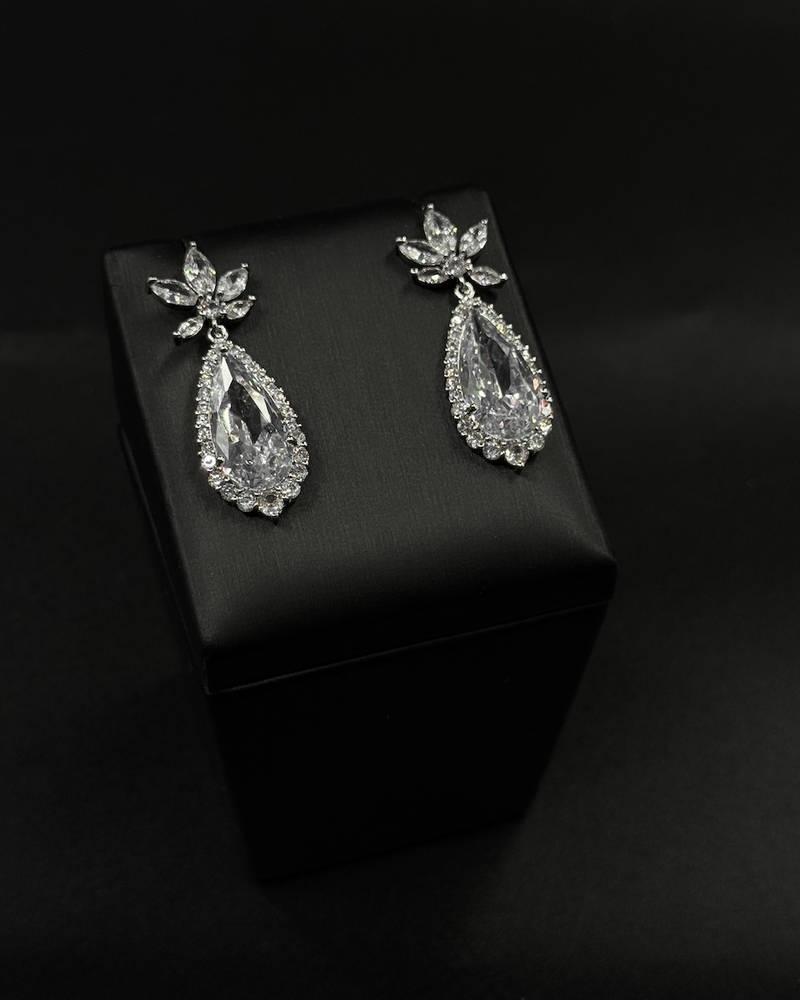 Teardrop earrings surrounded by small stones