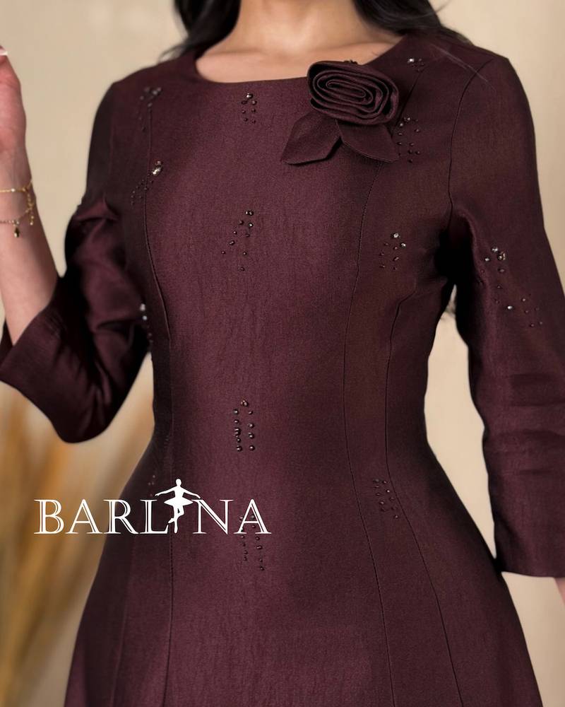 A soft midi dress adorned with a delicate rose