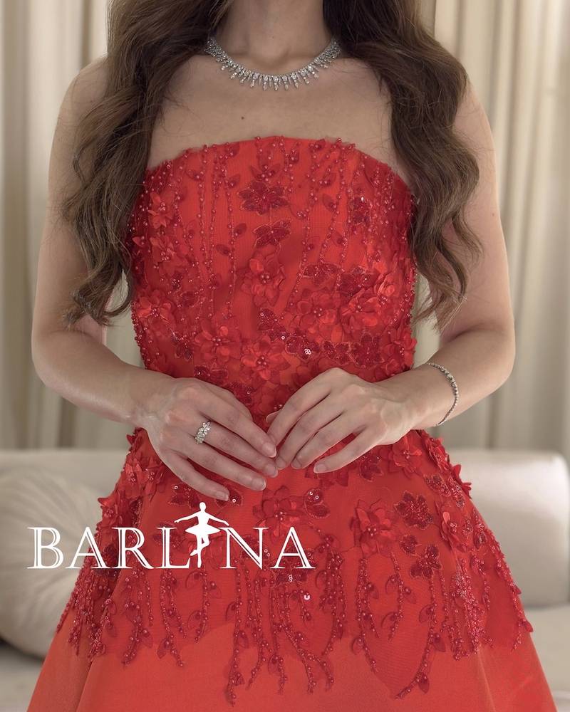 Red sleeveless dress with prominent floral patterns
