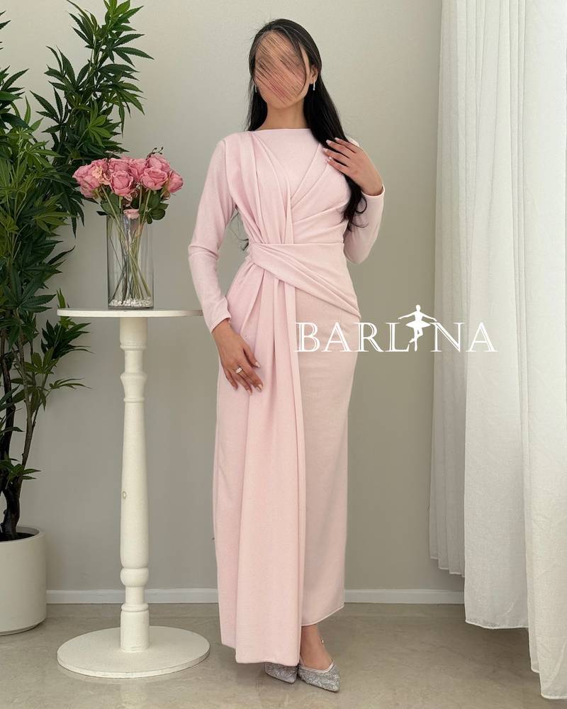 A soft pink dress with elegant details at the waist