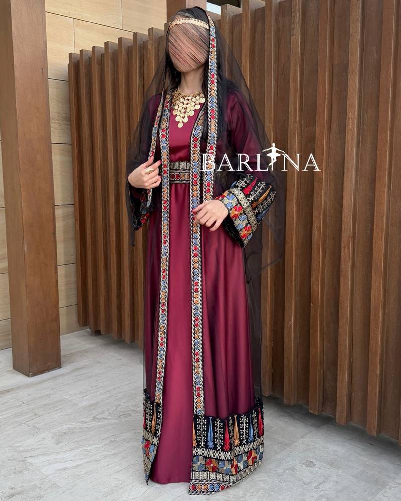 Red jalabiya with colorful traditional embroidery