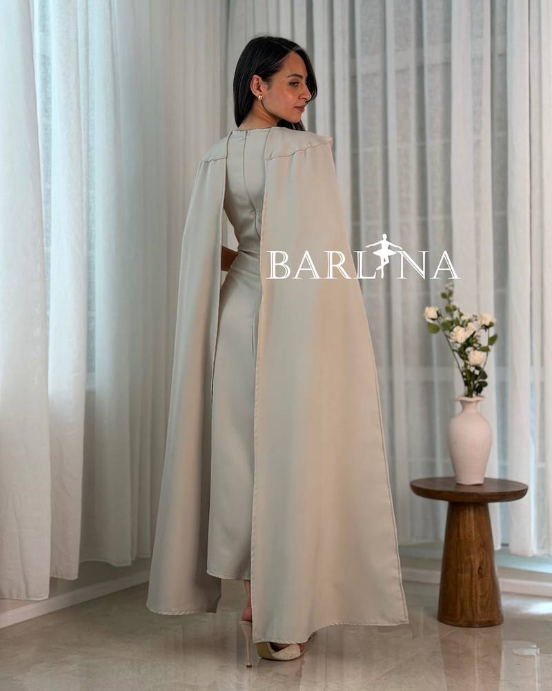 Beige dress with a cape design embellished with crystals