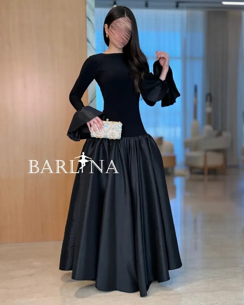 Elegant black dress with a high-cut top and long sleeves