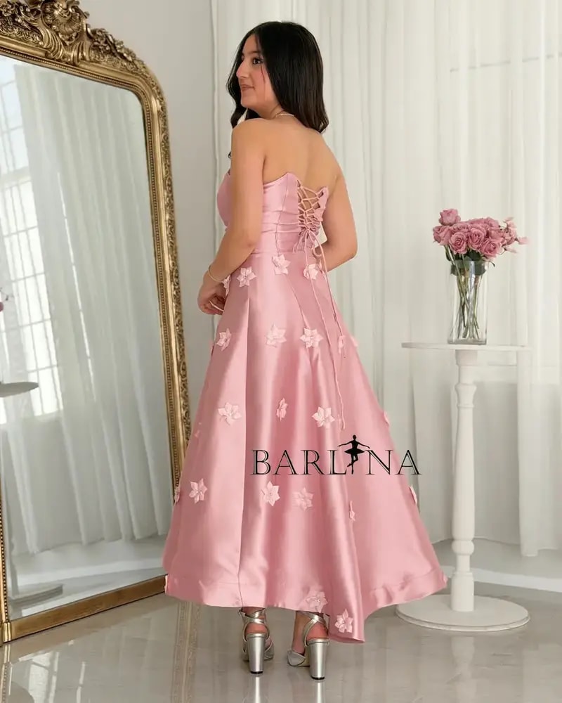A pink dress with floral details for the age-confusing occasion.