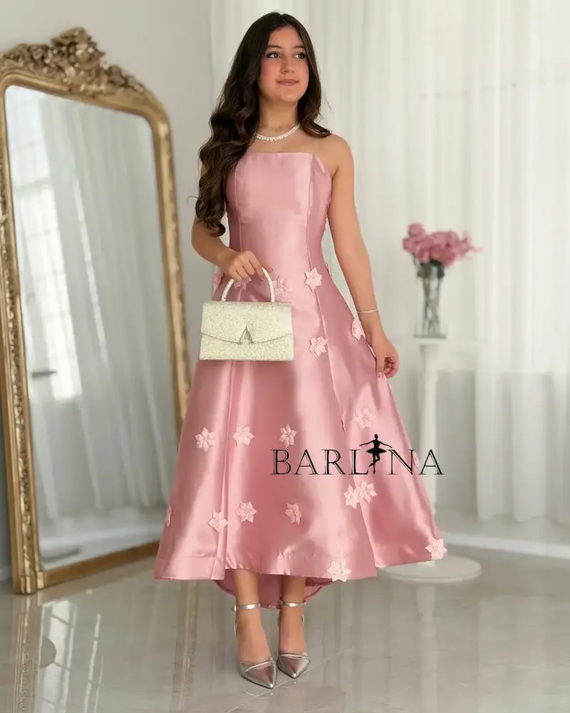 A pink dress with floral details for the age-confusing occasion.