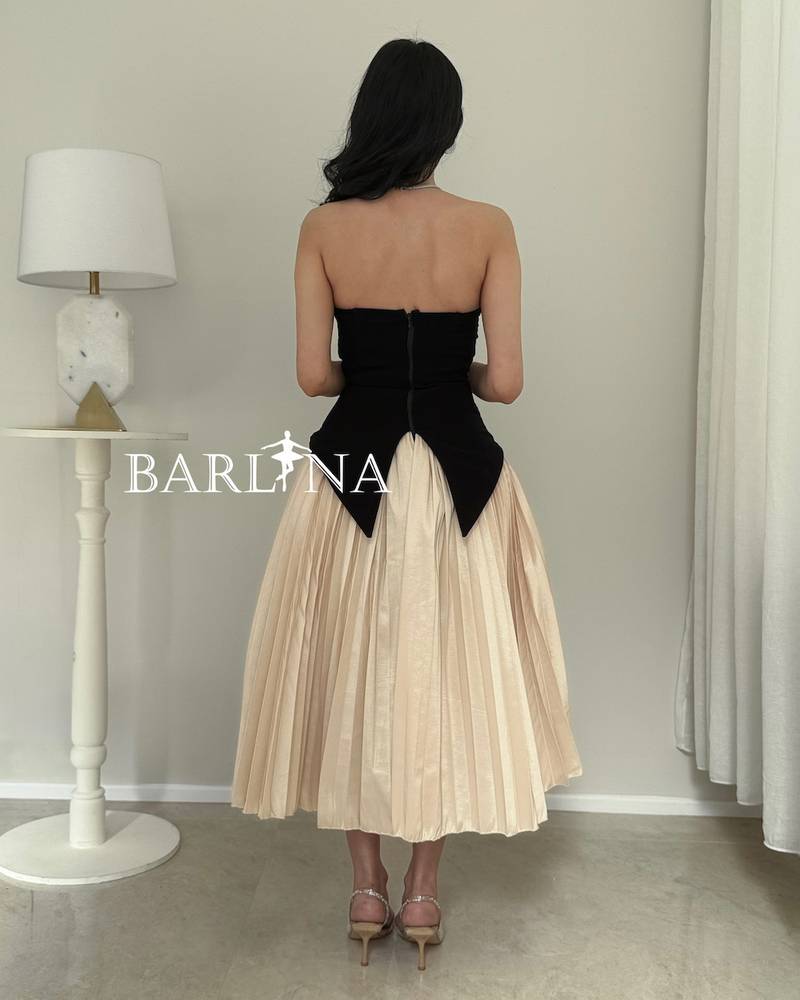 A soft, elegant dress with a corset cut and stylish pleats.