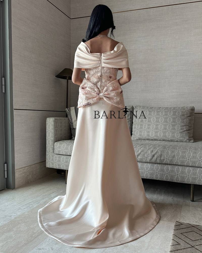 Cream evening dress with an elegant back bow