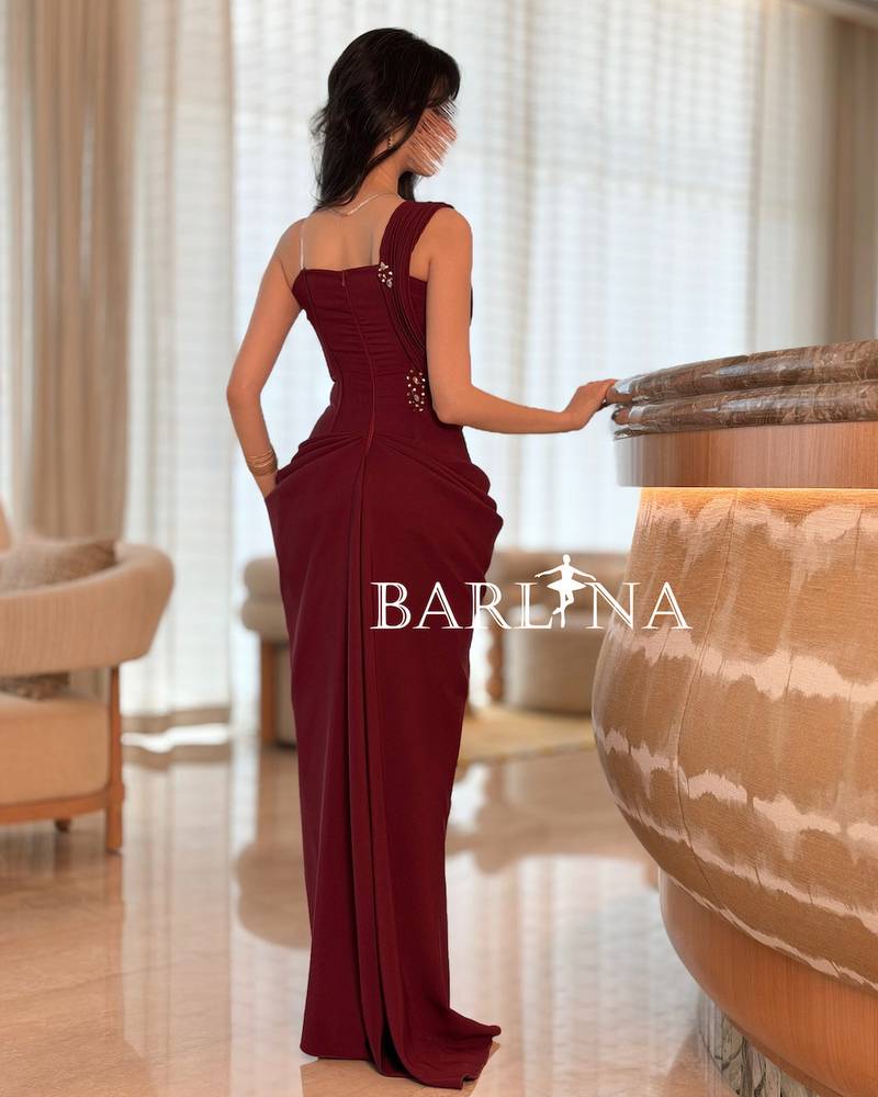Burgundy dress with shimmering embroidery and draped design