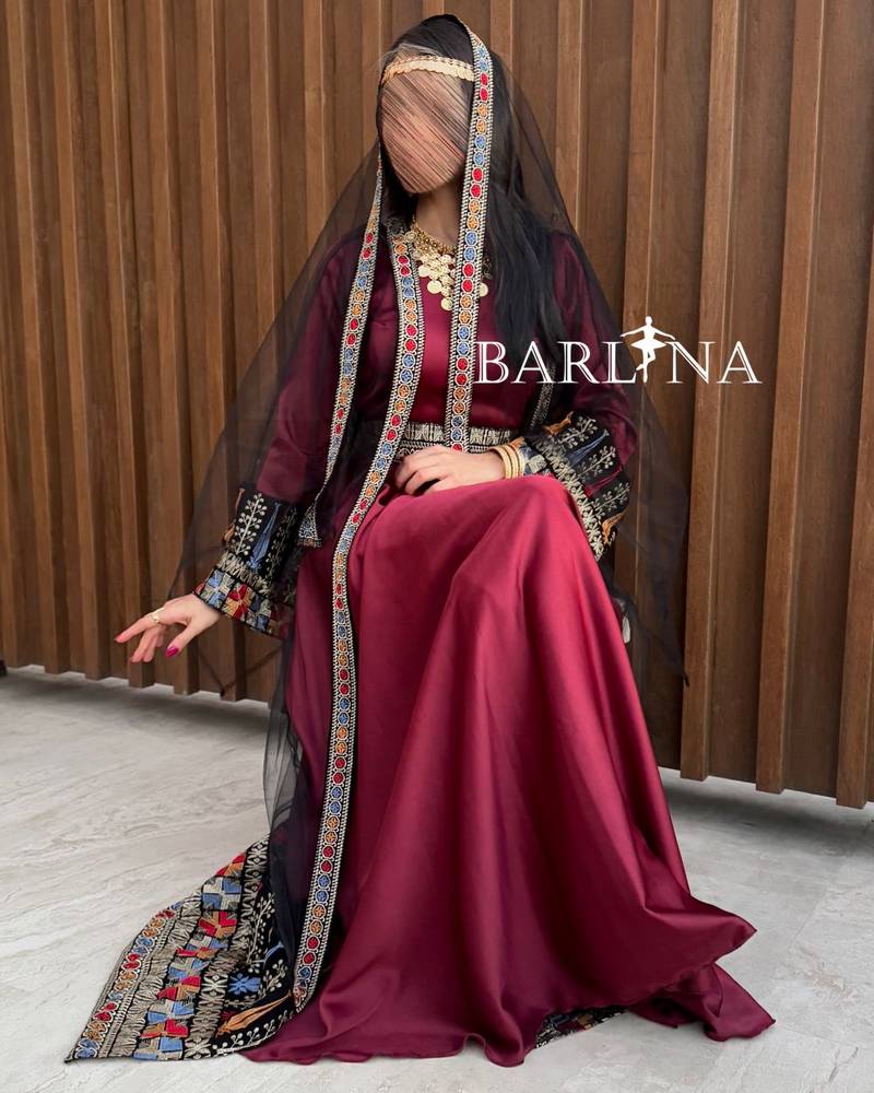 Red jalabiya with colorful traditional embroidery