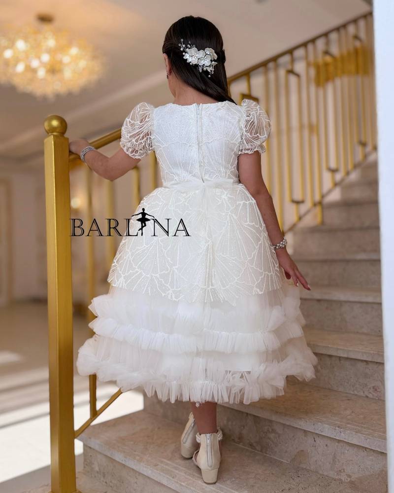 White patterned girl's dress with ruffled edges