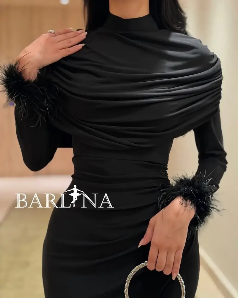 Black draped dress with feather-trimmed sleeves