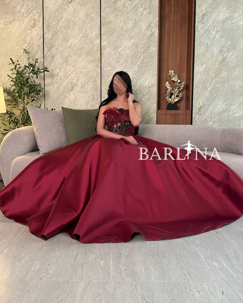 Burgundy dress with prominent beaded and sequin embroidery
