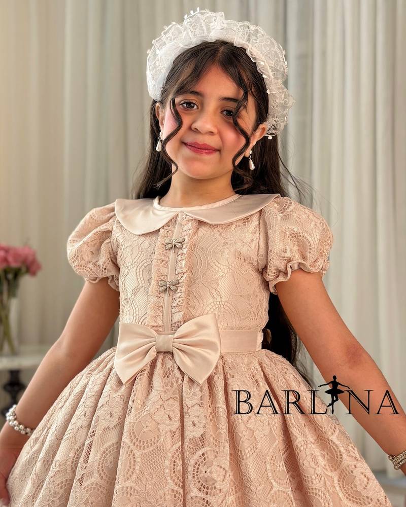 Beige girl's dress with a bow belt