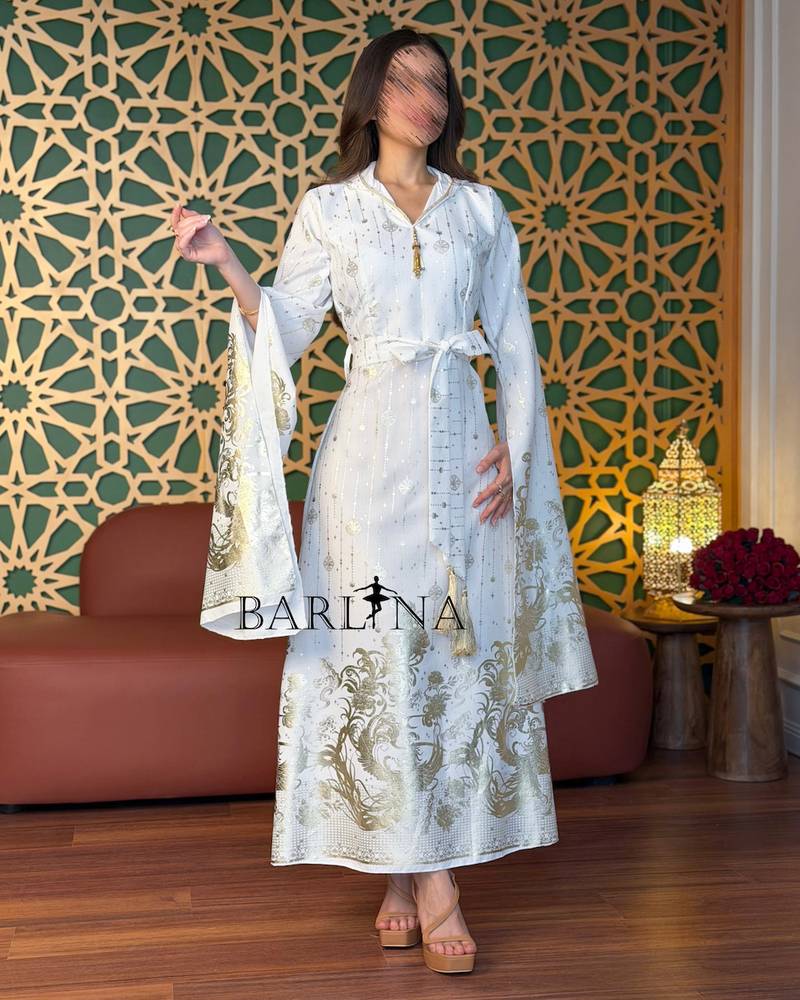 White jalabiya embroidered with gold and with flowing sleeves