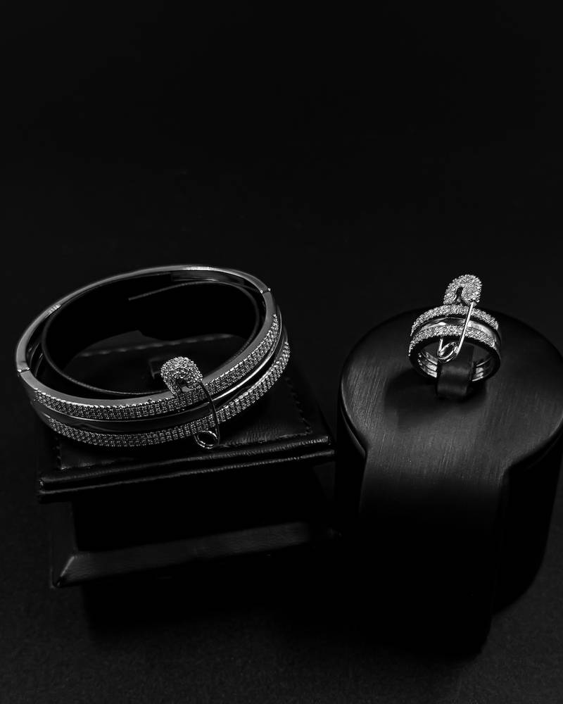 Bracelet and ring designed with crossed studded lines