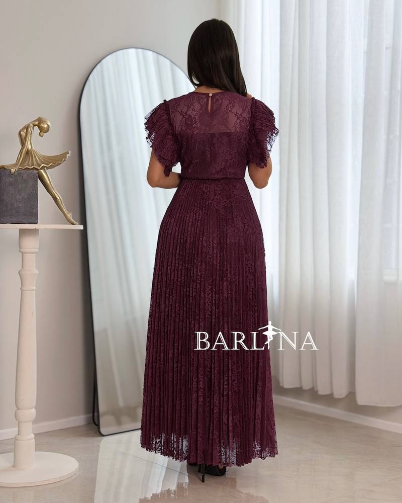 A burgundy dress made of lace fabric with ruffled sleeves