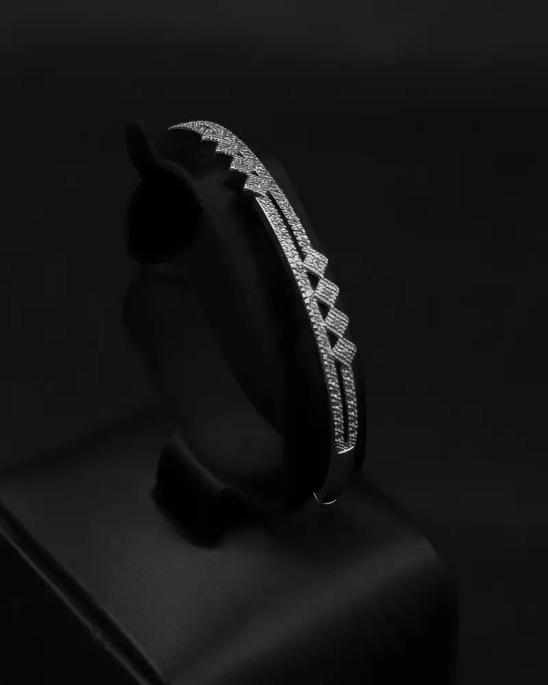 A delicate bracelet and ring with an interlocking, studded design.