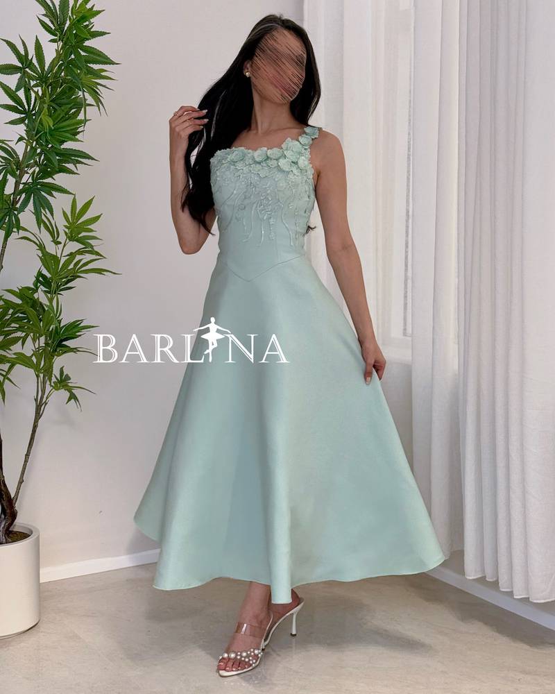 A soft Tiffany dress adorned with delicate rose embroidery